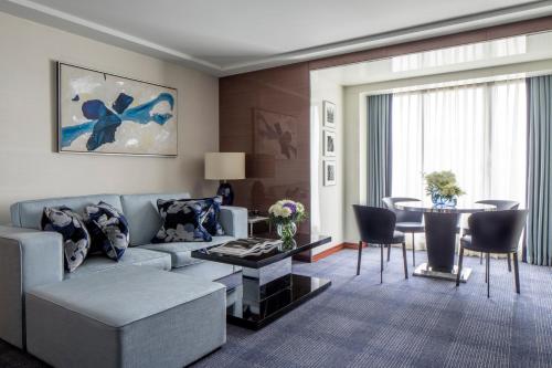 a living room with a couch and a table at Four Seasons Hotel London at Park Lane in London