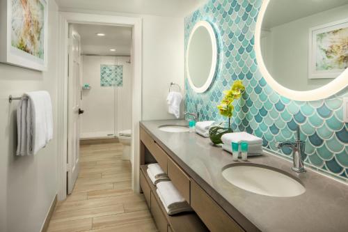 a bathroom with two sinks and a large mirror at Hyatt Vacation Club at Sunset Harbor in Key West