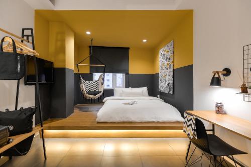 a bedroom with a large bed and a desk at The Hammock Hotel Fine Arts Museum in Ho Chi Minh City
