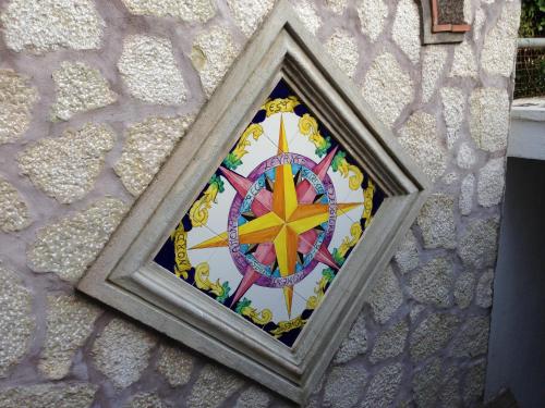 a mosaic clock on the side of a building at Hotel 4 Stagioni in Capri