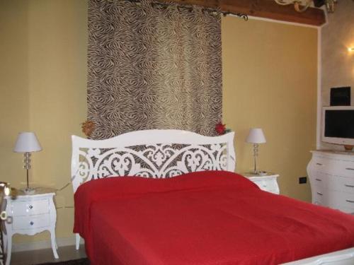 a bedroom with a red and white bed with two night stands at Al Parco in Ravenna
