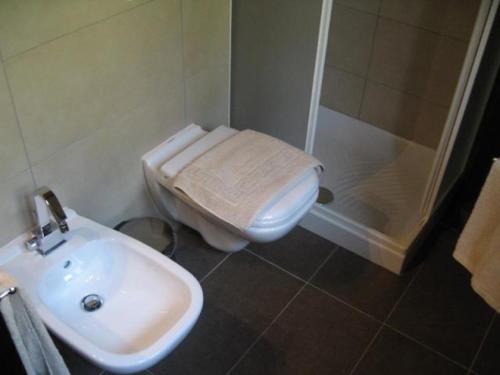 a bathroom with a toilet and a sink and a shower at Al Parco in Ravenna