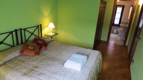 a bedroom with a bed in a room with green walls at Agriturismo La Staffa in Valeggio sul Mincio