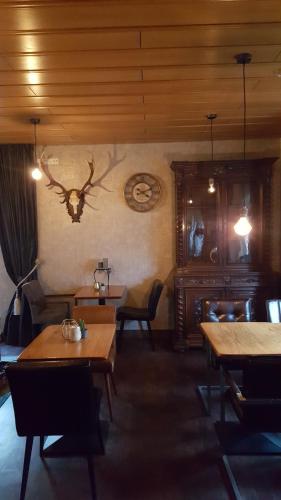 a dining room with wooden tables and chairs at Pension Abshoff in Meschede