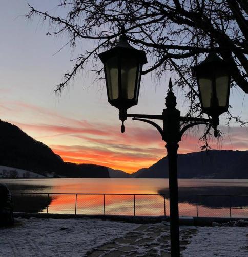 a street light with a sunset in the background at Havila Hotel Raftevold in Hornindal