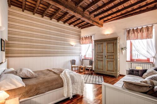 a bedroom with a bed and a couch at Colosseo Miracle Suite in Rome