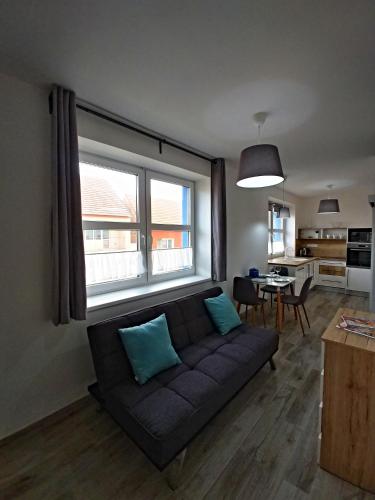 a living room with a couch and a table at Penzion jako víno in Bulhary