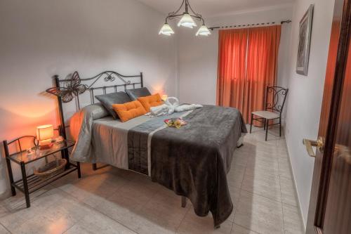 a bedroom with a large bed with orange pillows at God´s Finger in Agaete