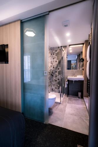 a bathroom with a shower and a toilet and a sink at Bulvar Hotel in Gorzów Wielkopolski