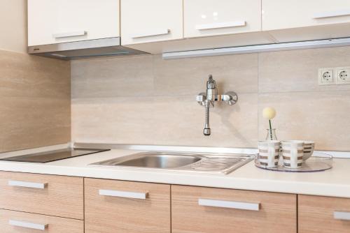 a kitchen with a sink and white cabinets at Villa Slavica 1 in Vodice