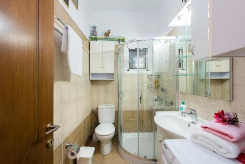 a bathroom with a shower and a sink and a toilet at Doris House by GuestCorfu in Corfu