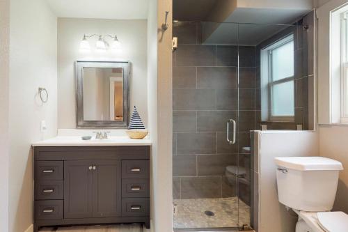 a bathroom with a shower and a sink and a toilet at South Bay Inn in Anna Maria