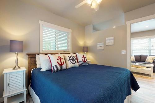 a bedroom with a blue bed with pillows at South Bay Inn in Anna Maria