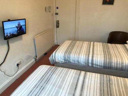 Кровать или кровати в номере Glades House