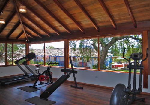 a gym with two treadmills and exercise bikes at Hacienda Hosteria Chorlavi in Ibarra