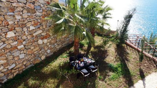an overhead view of a table and palm trees next to a wall at Blue Lagoon Village in Gazipasa