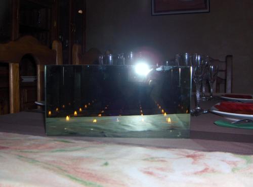 a person is taking a picture of a glass fireplace at Le Jardin Des Epices in Taroudant