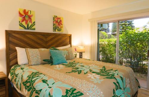 a bedroom with a large bed and a window at Puamana 4D Golf Courses Condo in Princeville