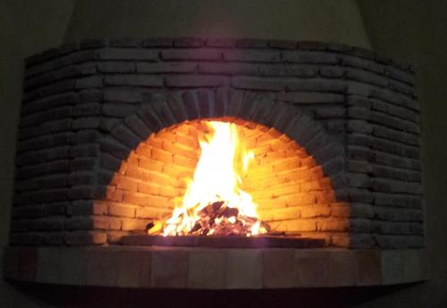 a brick oven with a fire in it at Le Jardin Des Epices in Taroudant