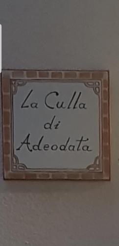 a sign that reads la collilia at adologia at La Culla di Adeodata in Marsala