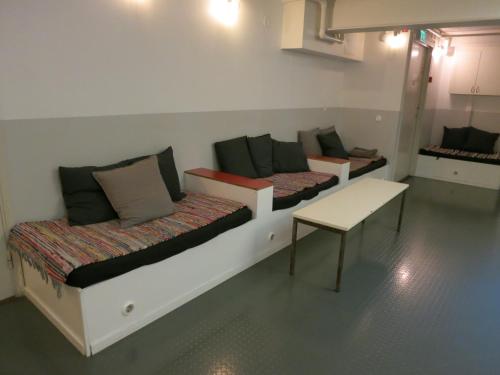 a room with two beds and a table at City Backpackers Hostel in Stockholm