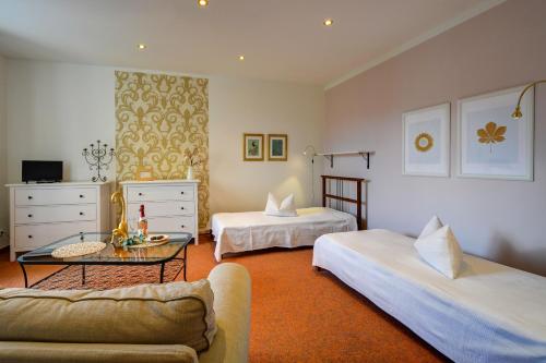 a living room with two beds and a couch at Pension Vila Hana in Loket