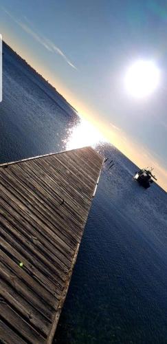 a boat on the water next to a wooden pier at La Culla di Adeodata in Marsala
