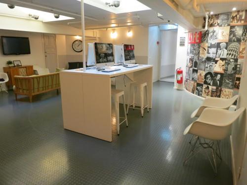 a room with a desk with chairs and a clock at City Backpackers Hostel in Stockholm