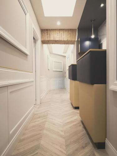 a hallway with white walls and wooden floors at Hotel Roma Vaticano in Rome