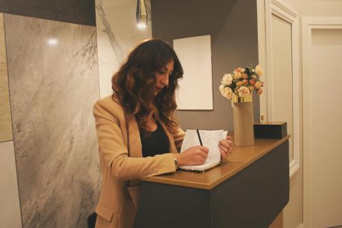 a woman standing at a counter in a bathroom at Hotel Roma Vaticano in Rome