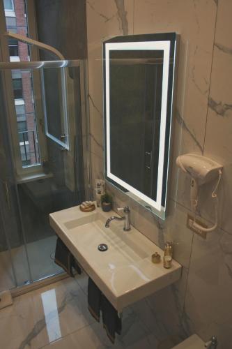 a bathroom with a sink and a mirror and a shower at Hotel Roma Vaticano in Rome