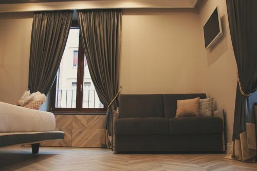 a living room with a couch and a window at Hotel Roma Vaticano in Rome