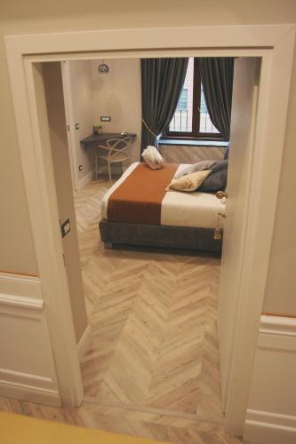 a bedroom with a bed and a desk and a window at Hotel Roma Vaticano in Rome