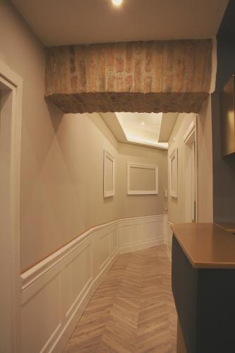 an empty hallway with a wooden floor and a brick ceiling at Hotel Roma Vaticano in Rome