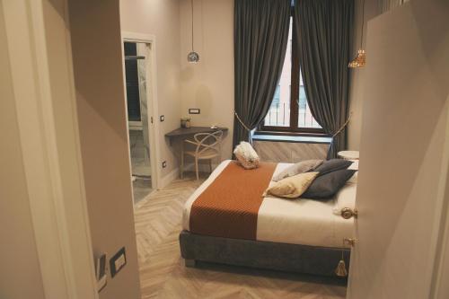 a small bedroom with a bed and a window at Hotel Roma Vaticano in Rome
