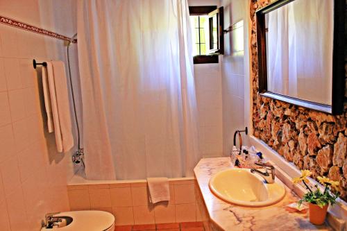 a bathroom with a sink and a shower at Agroturismo Can Fuster in Sant Joan de Labritja