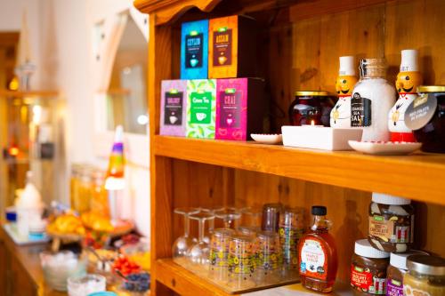a wooden shelf with bottles and jars on it at Carnately Lodge in Ballycastle