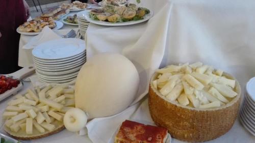 a table with plates of food on a table at Le Nicchie Guest House in Lucera