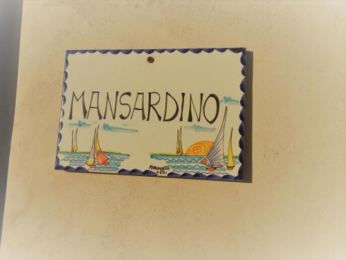 a sign hanging on a wall with a sail boat at Mansardino in Malcesine