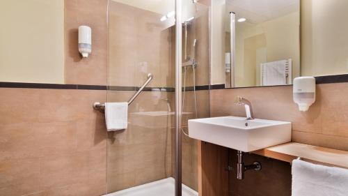 a bathroom with a sink and a shower at Silken Ordesa in Torla