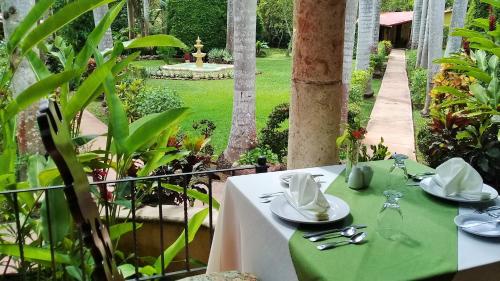 a table topped with a table cloth next to a pool of water at Hacienda Chichen Resort and Yaxkin Spa in Chichén-Itzá