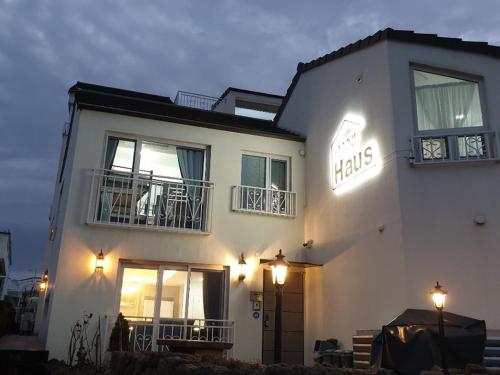 a white building with lights on the side of it at HANI Haus in Jeju