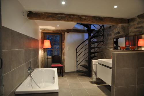 a bathroom with a bath tub and a staircase at Le Jardin de Beauvoir in Lyon
