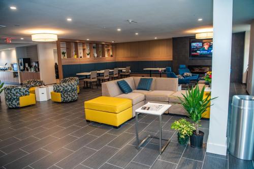 a lobby with a couch and chairs and tables at Microtel Inn & Suites by Wyndham Carlisle in Carlisle