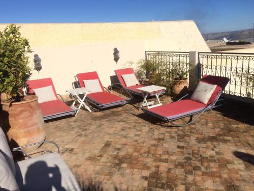 a group of chairs sitting on a patio at Dar Abdesalam in Fès