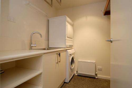 a kitchen with a sink and a washing machine at Apartment K2 14 in Mount Buller