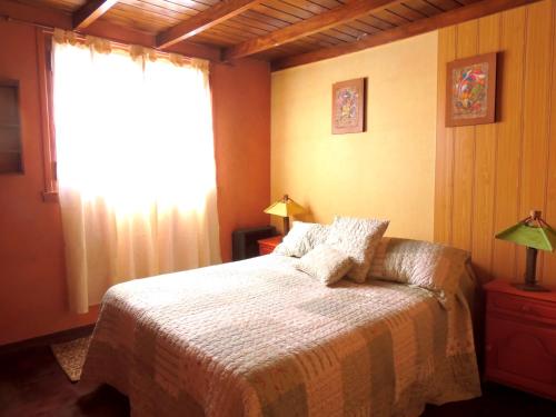a bedroom with a bed and a window at Ezenahí de la Cruz del Mar in Mar del Plata
