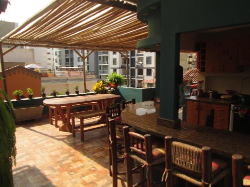 a patio with a table and chairs on a balcony at La Casona Azul in Lima