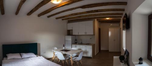 a bedroom with a bed and a table with chairs at Stara kuća Estate in Ljubuški