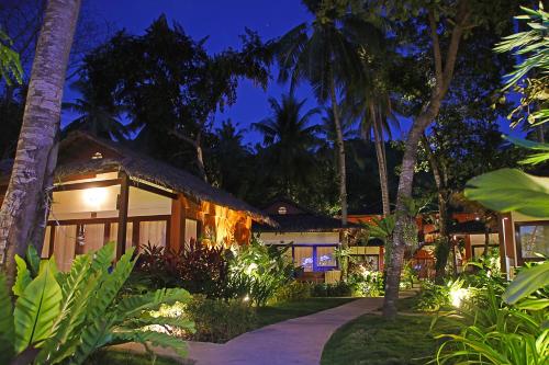 a resort at night with lights in the yard at Last Frontier Beach Resort-Adults Only in El Nido
